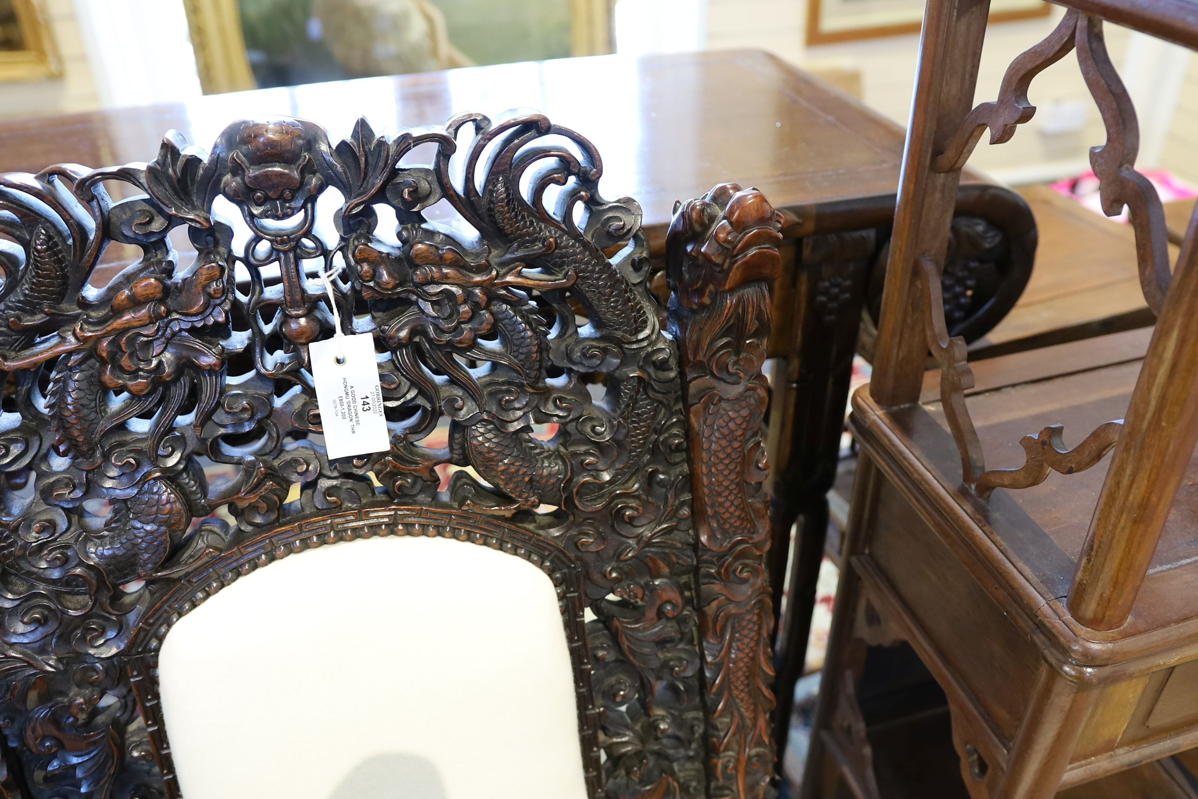 A good Chinese hardwood ‘dragon’ throne armchair, c.1900, 114.5cm high, 68cm wide at the arms